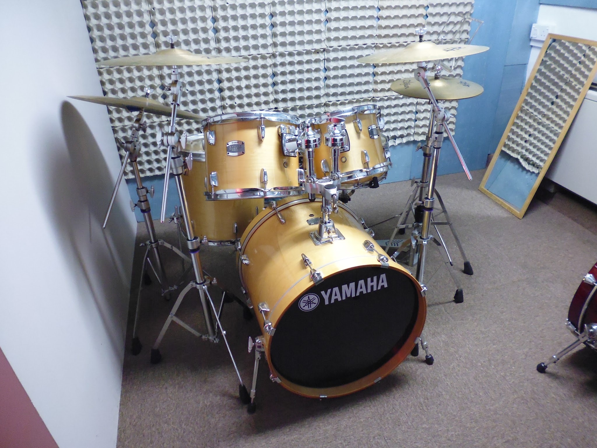 Gold Yamaha drum kit in the sound-treated studio